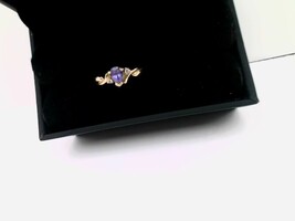 Cute 10kt Yellow Gold Ring with a purple stone and two small Diamonds $199.00