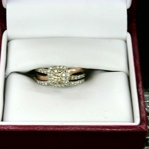 middle stone is a yellow canary diamond set in a rose gold band