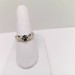 Unqiue 10kt Gold Ring with Hands Holding black and diamond stones.  $179.00